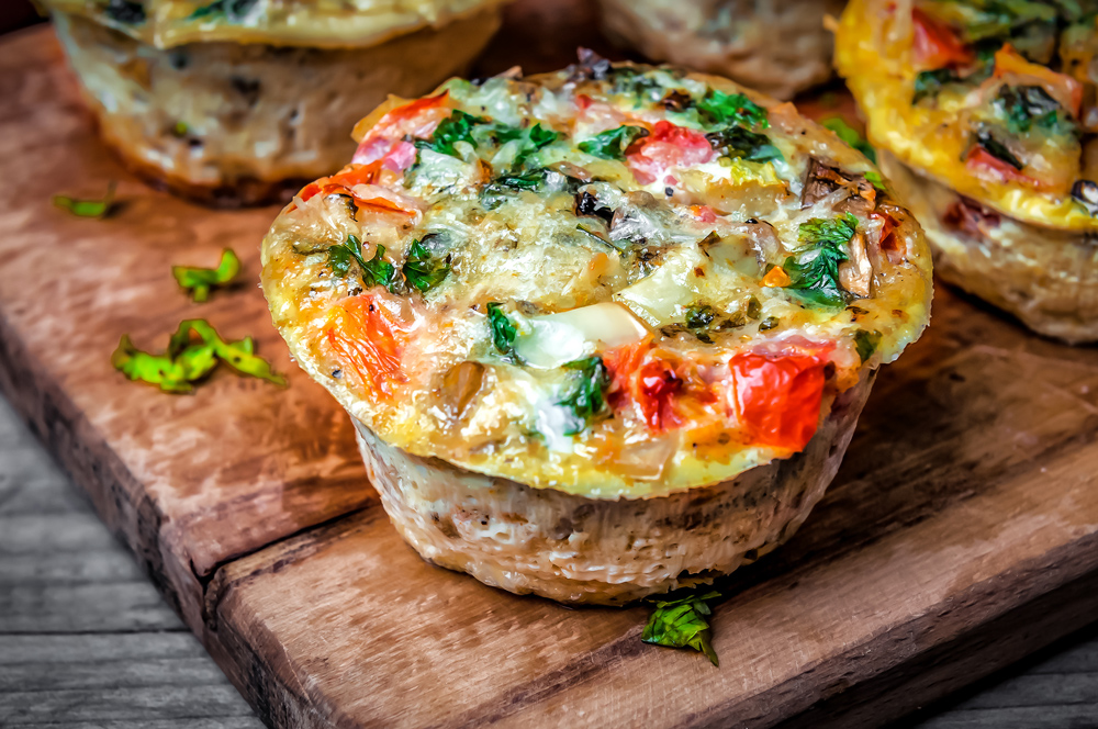 Mediterranean egg cups with spinach, tomatoes, mushrooms, eggs, spinach crumbles feta