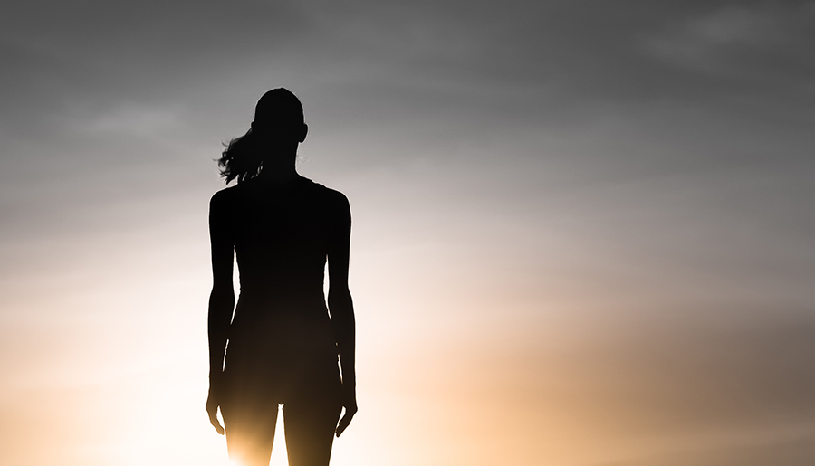 Woman silhouette looking into soft sky, Unexpected Perimenopause Symptoms to Watch For