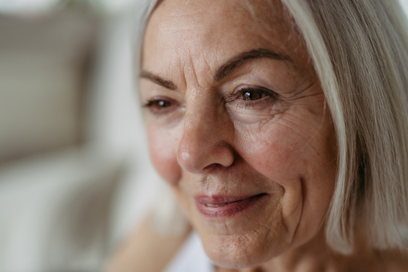 Menopause and your skin - aging expectations and ways to impact it on woman with white hair and partial smile